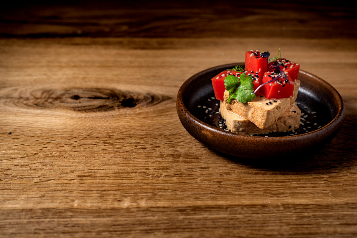 Tofu with tomato jelly, green pesto and sesame seeds